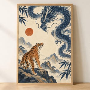 May include: A framed wall art print featuring an orange tiger standing on a rocky cliff looking up at a large blue dragon in the sky. The scene includes a red sun, misty mountains, and dark blue bamboo leaves, all enclosed in a light wood frame.