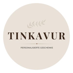 May include: A circular logo with the word "TINKAVUR" in dark brown, centered on a light beige background. Below the text is "PERSONALISIERTE GESCHENKE" in a smaller font. A small leaf design is at the top.