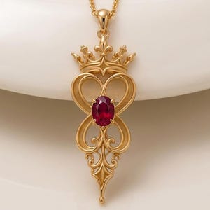 May include: A gold pendant necklace featuring an intricate, openwork design topped with a crown motif. The center of the pendant holds a single, oval-cut, deep red gemstone. The piece hangs from a delicate gold chain, showcasing a symmetrical, scroll-like metalwork pattern that tapers to a point at the bottom.