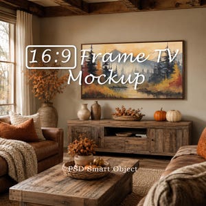 May include: A living room scene featuring a framed landscape painting above a wooden cabinet. The text "16:9 Frame TV Mockup" is visible. The room is decorated with fall-themed accents, including pumpkins and decorative vases.