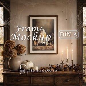 May include: A rectangular wooden frame mockup featuring a print of a ghost figure and rabbits. The text "Frame Mockup" and "DIN A" are visible. The frame is displayed on a wooden surface with a vase of dried flowers, white pumpkins, and candles.