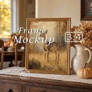 May include: A gold-toned rectangular picture frame containing a painting of a deer in a field. The text "Frame Mockup" is centered on the image, with "3:4" in a box on the right and "PSD Smart Object" at the bottom. The frame is vertical.