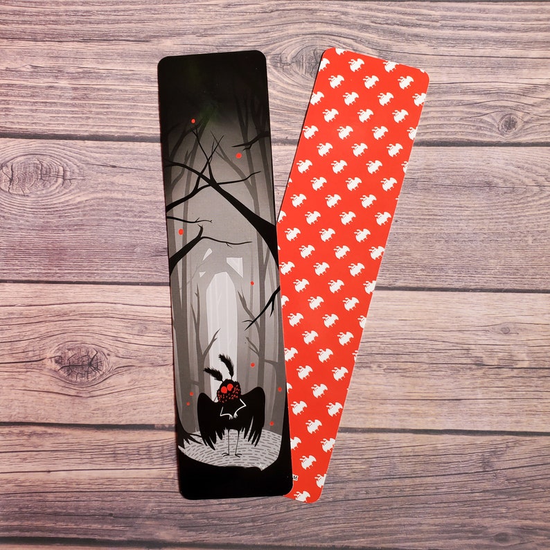 May include: Two bookmarks, one with a black and white illustration of a moth in a forest and the other with a red background and white repeating pattern.