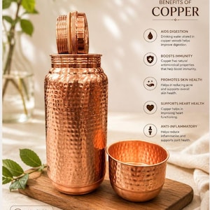 May include: A hammered copper water bottle with a matching lid and a small cup. The text reads: BENEFITS OF COPPER, AIDS DIGESTION, BOOSTS IMMUNITY, PROMOTES SKIN HEALTH, SUPPORTS HEART HEALTH, ANTI-INFLAMMATORY, and 100% PURE COPPER. Safe. Healthy. Sustainable.