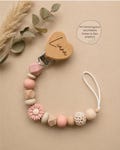 Personalized pacifier chain engraved with name in a floral design, various colors and clips for boys and girls, including gift bag. product logo