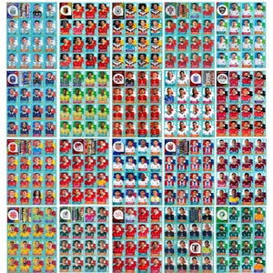 May include: A large sheet of collectible football trading cards featuring numerous individual player portraits arranged in a grid. Each card displays a headshot of a player, their name, and a national team flag icon, organised by country.