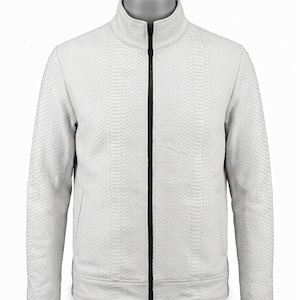 May include: A white, textured jacket with a snake-skin pattern. The jacket has a high collar, a black zipper down the front, and a ribbed hem. The jacket is displayed on a mannequin.