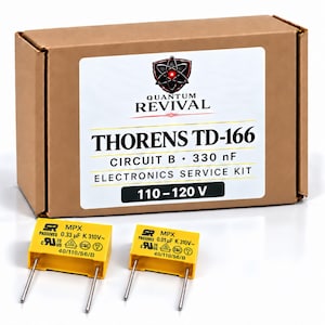 May include: A brown cardboard box containing a Quantum Revival electronics service kit for a Thorens TD-166, Circuit B, 330 nF, 110-120 V. Two yellow rectangular capacitors with metal pins are placed in front of the box, labeled 0.33 uF and 0.01 uF.