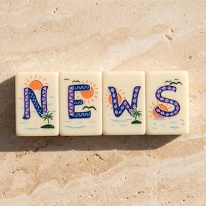 May include: Four off-white rectangular tiles arranged horizontally, each featuring a hand-painted letter spelling NEWS. Each tile displays a tropical scene with a bright orange sun, blue ocean waves, a small green palm tree, and a dark blue letter.