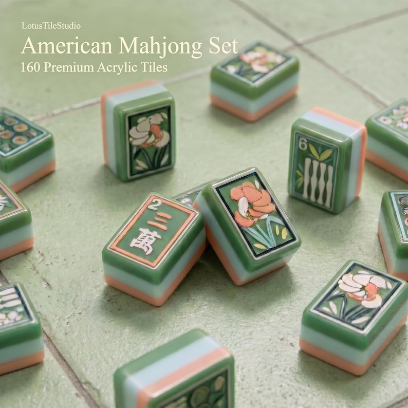 May include: A set of 160 premium acrylic tiles for an American Mahjong set. The tiles feature a layered design with a green top, a light blue middle, and a peach-colored base. Some tiles display floral illustrations, while others show numbers and symbols.