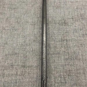 May include: A long, slender, metal tool with a pointed end. The tool is dark gray and appears to be made of steel. The tool has a textured surface and a small inscription near the base.