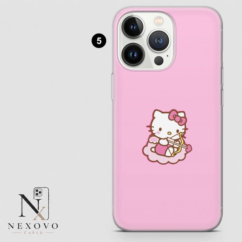 May include: Pink phone case featuring a Hello Kitty design as Cupid with a bow and arrow. The case has a glossy finish and is designed to fit a smartphone. The case has a camera cutout and button covers.