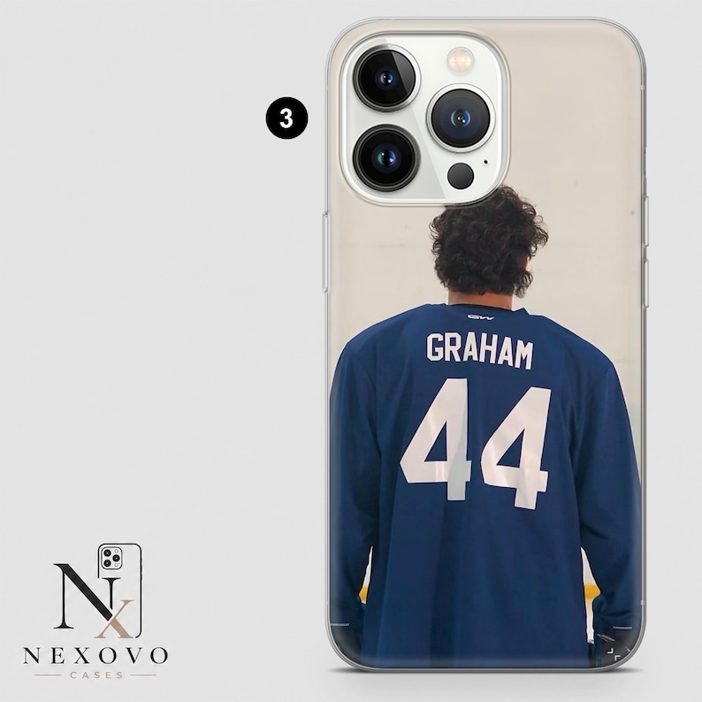 May include: Clear phone case featuring a navy blue jersey with the name "GRAHAM" and the number "44" in white. The case has a photo of a person wearing the jersey. The phone case is from Nexovo Cases.