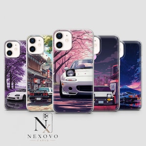 May include: Five phone cases featuring anime-style illustrations of Japanese sports cars. Designs include a white car under purple trees, a black car in a street, a white car under cherry blossoms, a car at a gas station, and a car near Mount Fuji.