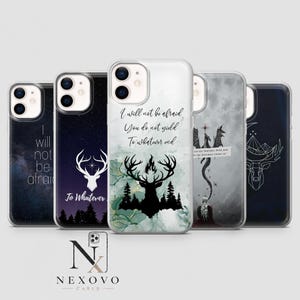 May include: Five clear phone cases featuring various designs including a white stag silhouette, a black deer head with forest trees, a dragon illustration, and text quotes such as I will not be afraid, You do not yield, and To whatever end.
