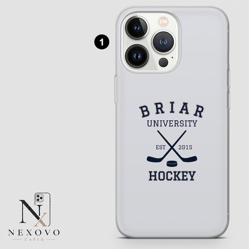 May include: A white phone case with a navy blue Briar University Hockey design. The design includes crossed hockey sticks, a puck, and the text "EST 2015". The case has a clear, protective design.