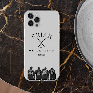 May include: A clear phone case featuring the text "BRIAR UNIVERSITY - HOCKEY" with crossed hockey sticks. Below, four figures are shown with jersey numbers 44, 22, 66, and 46. The case is on a dark, patterned surface.
