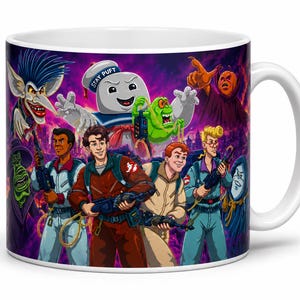 May include: A white ceramic mug featuring a colorful graphic illustration of Ghostbusters characters and various ghosts, including the Stay Puft Marshmallow Man, Slimer, and a pumpkin-headed figure against a vibrant purple and orange background.