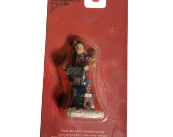 Figura de perro músico organillero de la colección St Nicholas Square Village (Nueva)