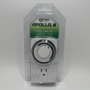 May include: A Titan Controls Apollo 6 24-hour programmable timer in clear plastic retail packaging. The white device features a circular analog dial with 15-minute intervals, a 120-volt outlet, and text specifying 15 amps, 60 Hz, and 120 volts.