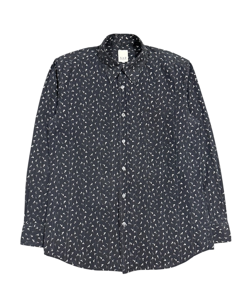 May include: A long-sleeve button-down shirt in dark charcoal gray featuring a repeating white pattern of small bird silhouettes and thin vertical pinstripes. The shirt has a standard collar, a front button placket, and a label reading AAR.