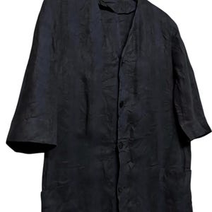 May include: A dark navy blue button-down shirt with a subtle tonal textured pattern, featuring a V-neckline, three-quarter length sleeves, and two front patch pockets. The garment is displayed on a wooden hanger labeled French Connection.
