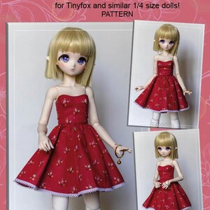May include: A red cotton open-shoulder dress pattern for Tinyfox and similar 1/4 size dolls. The dress features a floral print and a white lace trim. The image includes three doll images wearing the dress.