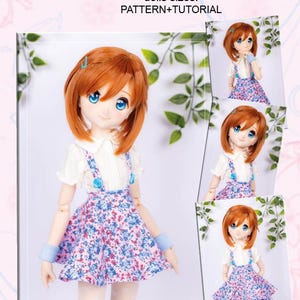 May include: A doll wearing a white blouse with a floral print skirt and blue suspenders. The doll has red hair and blue eyes. The image includes the text "JERSEY SKIRT WITH STRAPS" and "PATTERN+TUTORIAL".