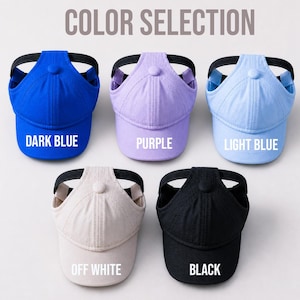 May include: Five ponytail baseball caps arranged in two rows, featuring a top button and a black elastic band opening. The colors are labeled as Dark Blue, Purple, Light Blue, Off White, and Black. The text Color Selection appears at the top.