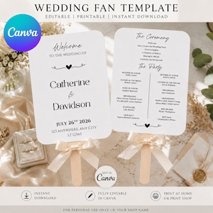 May include: Two white wedding fan templates with rounded corners, featuring black text and a small heart graphic. Each fan is attached to a wooden handle and decorated with a cream-colored satin ribbon bow. The text includes wedding details.