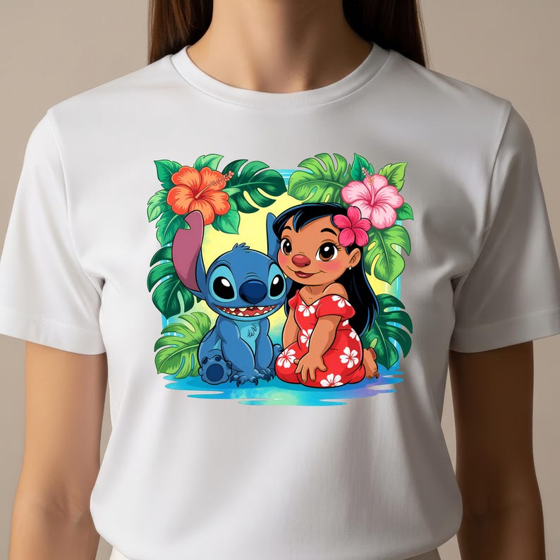 May include: White t-shirt featuring a colorful graphic of Lilo and Stitch, surrounded by tropical flowers and foliage. Lilo is wearing a red dress with white flowers, and Stitch is blue. The design is set against a yellow and blue background.