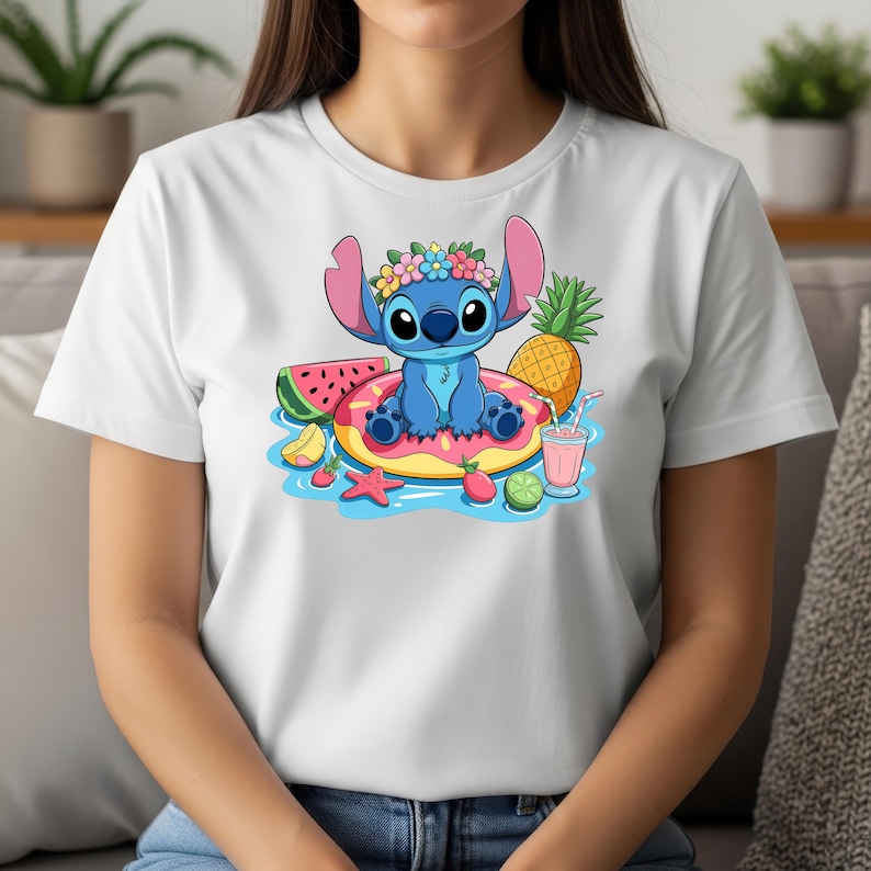 May include: White t-shirt featuring a cartoon image of Stitch, the blue alien, relaxing on a pink donut float with tropical fruits. Stitch wears a flower crown. A pineapple, watermelon, and a pink drink are also shown.