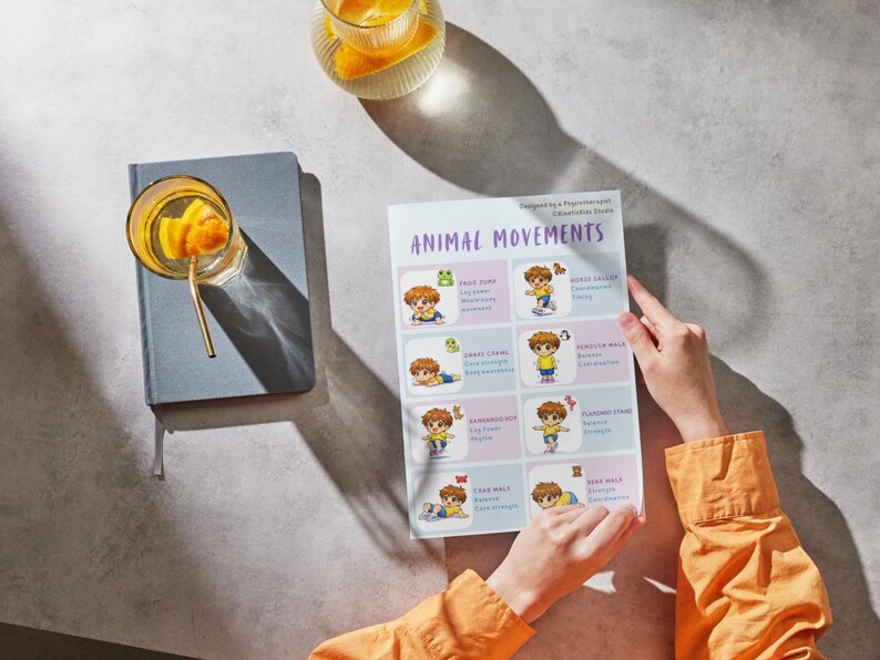 May include: A person holding a printed sheet titled "ANIMAL MOVEMENTS" with illustrations of children performing various exercises. The sheet is on a gray surface next to a blue notebook and a glass of orange-infused water.