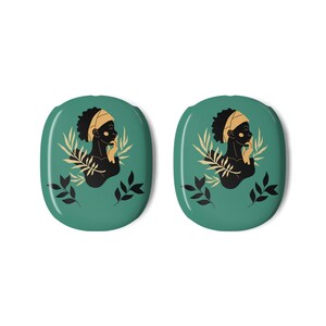 Op de afbeelding: Twee ovale, teal-gekleurde objecten met een zwart silhouet van een persoon met een hoofddoek en gouden accenten. Het ontwerp bevat gouden en zwarte bladeren. De objecten zijn identiek.