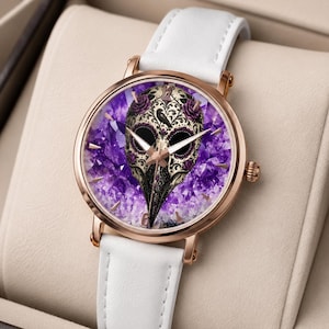 May include: A wristwatch with a white leather strap and a rose gold-tone metal case. The watch face features a detailed plague doctor mask illustration centred over a vibrant purple amethyst crystal background, with rose gold-tone hands.