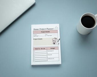 May include: A white Home Project Planner notepad with sections for project details, a tasks to-do list, and budget tracking. The page features a small graphic of a clipboard, magnifying glass, and pen. The layout includes lines for dates and costs.