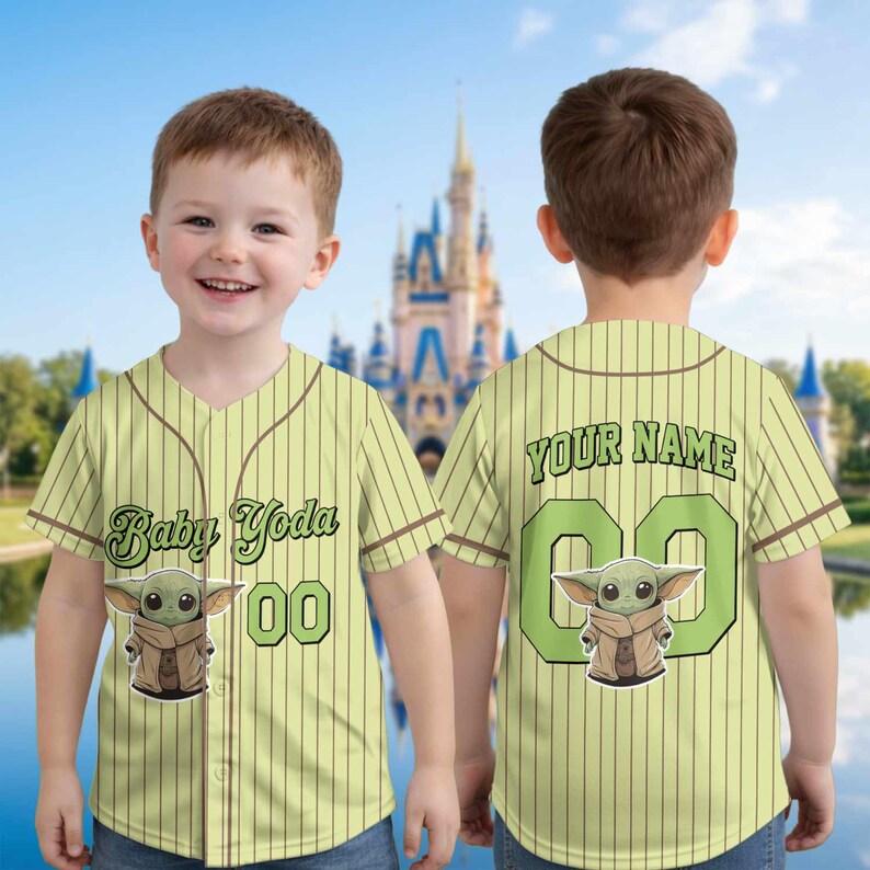 May include: A light green baseball jersey with brown pinstripes, featuring a Baby Yoda graphic and the text "Baby Yoda 00" on the front. The back of the jersey has the text "YOUR NAME" and the number "00".