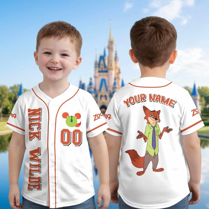 May include: A white baseball jersey with orange trim featuring the text NICK WILDE and the number 00 on the front. The back displays a graphic of a fox character wearing a green shirt and purple tie, with the customizable text YOUR NAME above it.