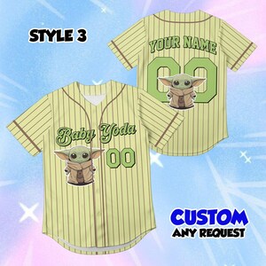 May include: A light green baseball jersey with brown pinstripes, featuring a Baby Yoda graphic and the text "Baby Yoda" and "00" on the front. The back has "YOUR NAME" and "00". The text "CUSTOM ANY REQUEST" is also visible.