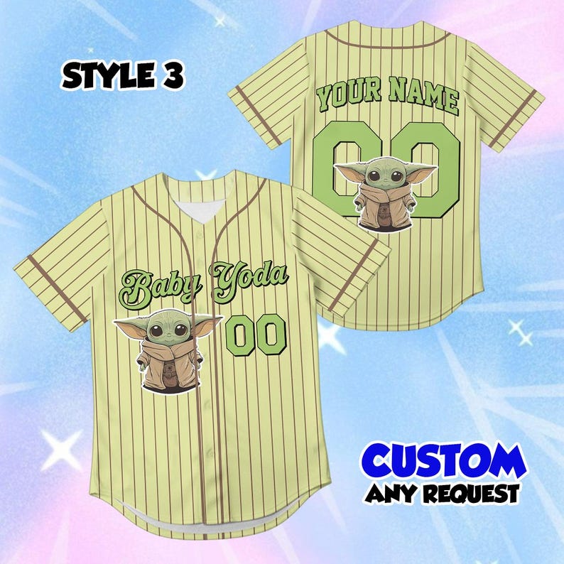 May include: A light green baseball jersey with brown pinstripes, featuring a Baby Yoda graphic and the text "Baby Yoda" and "00" on the front. The back has "YOUR NAME" and "00". The text "CUSTOM ANY REQUEST" is also visible.