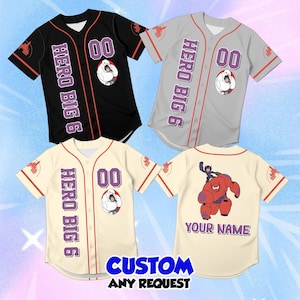May include: Three button-down baseball jerseys in black, gray, and cream, each featuring the text HERO BIG 6, the number 00, and a graphic of Baymax and Hiro. The back of the cream jersey displays a graphic of Baymax and Hiro with YOUR NAME.