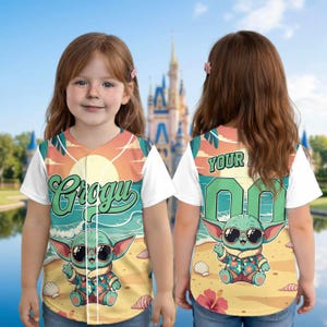May include: A baseball jersey featuring a cartoon Grogu character in sunglasses on a beach scene. The front of the jersey has the name "Grogu" in green script. The back has the word "YOUR" above a number. The jersey has white sleeves.