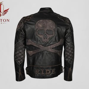 May include: Black leather jacket with a skull and crossbones design on the back. Features quilted shoulder and elbow patches, and the word "RIDE" is embossed at the bottom. Zippers on the sleeves.