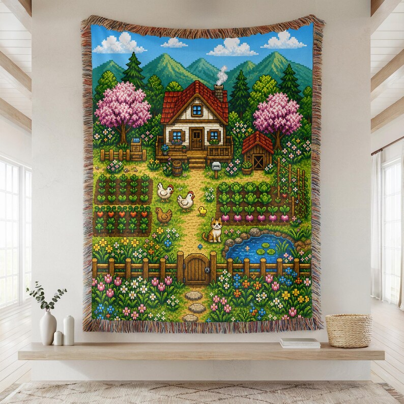 May include: A pixelated tapestry depicting a charming farm scene with a house, garden, pond, and animals. The artwork features a blue sky, green trees, and colorful flowers. The tapestry has a fringed edge and is displayed on a wall.