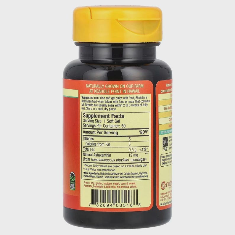 May include: A black supplement bottle with a yellow cap. The label includes text about the product's ingredients and usage, including "Natural Astaxanthin" and "Keahole Point in Hawaii". The bottle contains 50 soft gels.