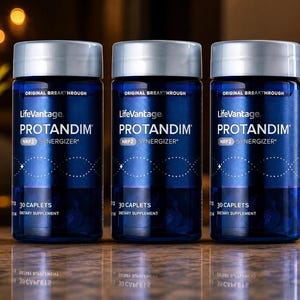 May include: Three identical dark blue cylindrical bottles of LifeVantage Protandim NRF2 Synergizer dietary supplement. Each bottle features a silver cap, white text stating 30 caplets, and a graphic of a DNA strand on the front label.