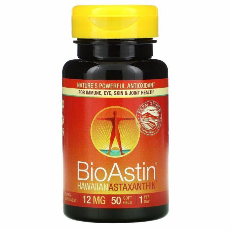 May include: A bottle of BioAstin Hawaiian Astaxanthin dietary supplement. The bottle is black with a yellow cap and a red label. The label includes text about the product's benefits and the dosage: 12 mg, 50 soft gels, 1 per day.