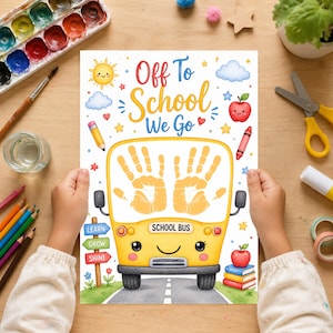 May include: A white paper print titled Off To School We Go featuring a yellow school bus illustration with two yellow handprints on the windshield, surrounded by colorful drawings of a sun, clouds, apples, pencils, and a signpost with text.