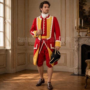 May include: A red and yellow military-style coat with silver buttons, a matching red vest, and red knee-length breeches. The outfit includes a white neck cravat, a black tricorne hat held in one hand, and brown leather buckled shoes.