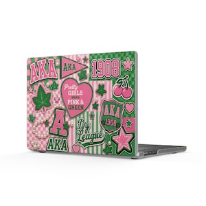 May include: A laptop skin featuring a pink and green collage with the text AKA, 1908, Ivy League, and Pretty Girls Wear Pink & Green. The design includes cherry icons, ivy leaves, stars, hearts, a pennant, and a string of white pearls on a checkered background.